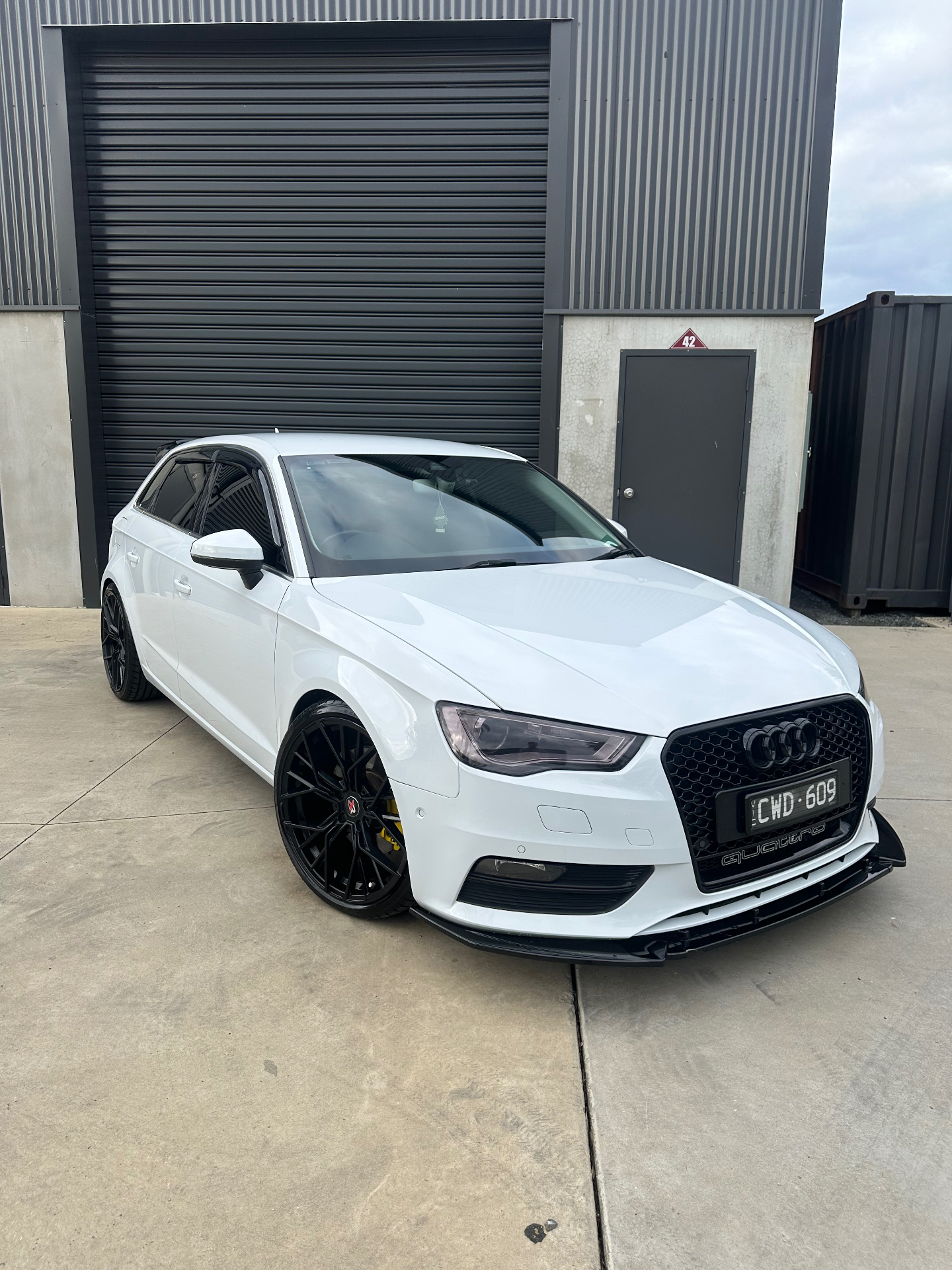 White Audi detailed outside Diamond Detail Co. studio