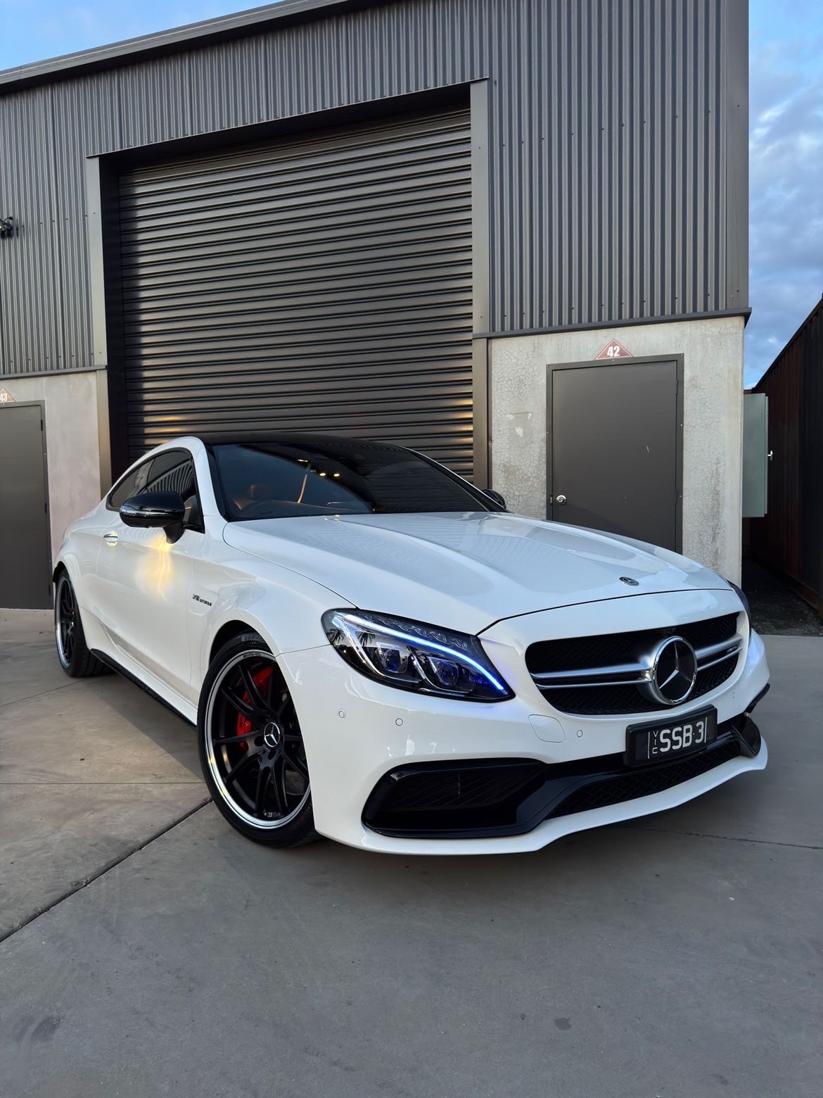 White Mercedes coupe front angle after paint correction