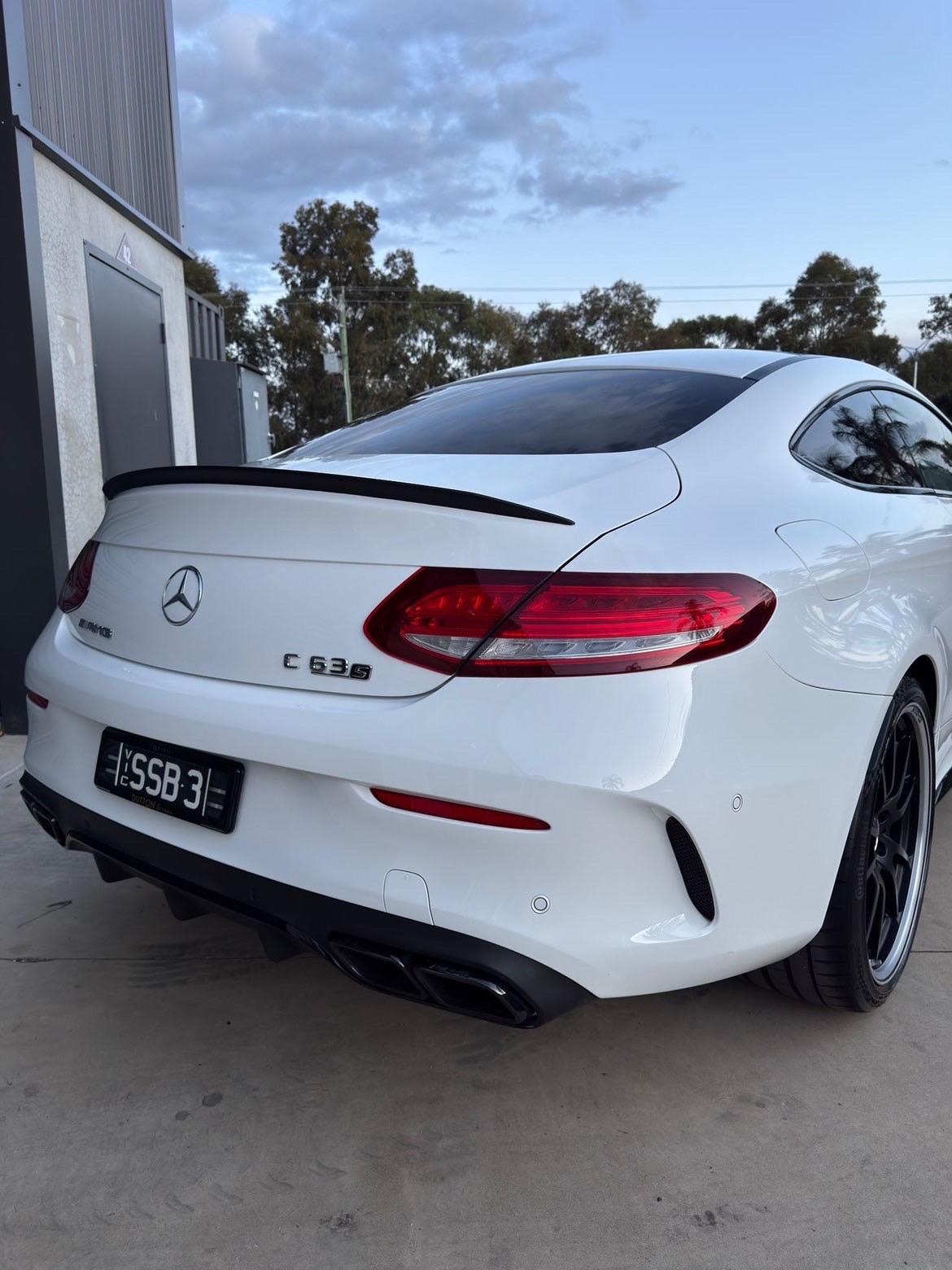 White Mercedes coupe rear angle after detailing